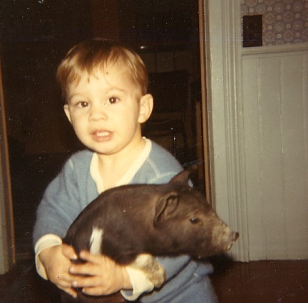 my bother and a baby pig in the house